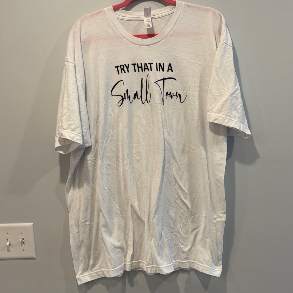 Needs stain treated. Stain on back Tultex White Tee with Black Text